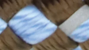 Woven pattern with olive brown strands crossed over light blue and white strands.