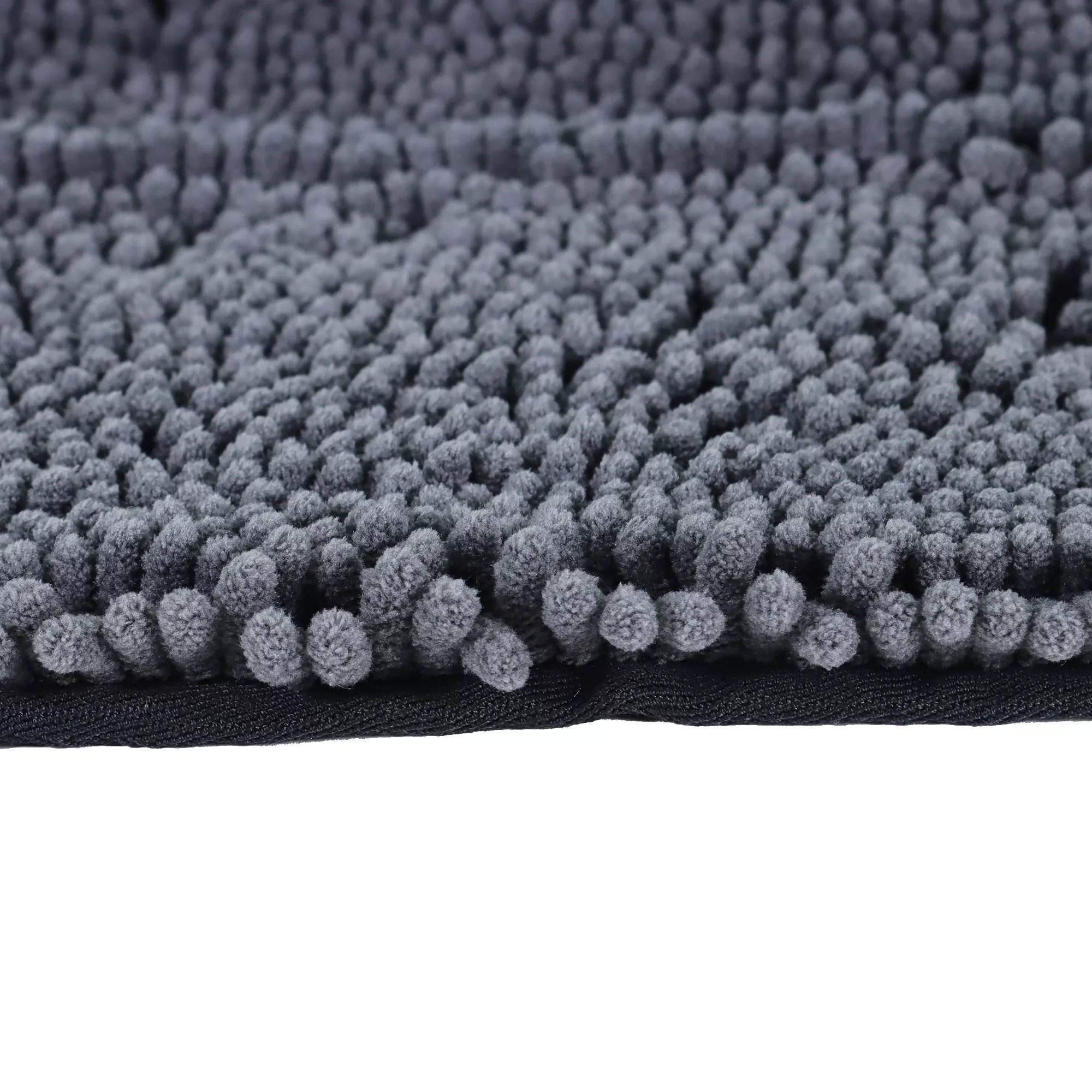 A close‑up of a gray shammy towel laid flat. The towel surface is covered with short, looped microfiber strands forming a dense, textured pattern.