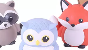 A set of latex dog toys shaped like woodland animals including a raccoon, owl, and fox.
