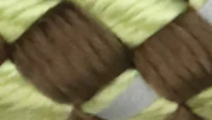 Woven pattern with light olive green strands crossed over dark brown strands.