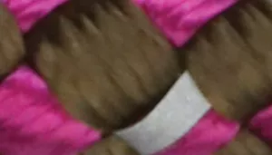 Woven pattern with dark brown strands crossed over bright magenta strands.